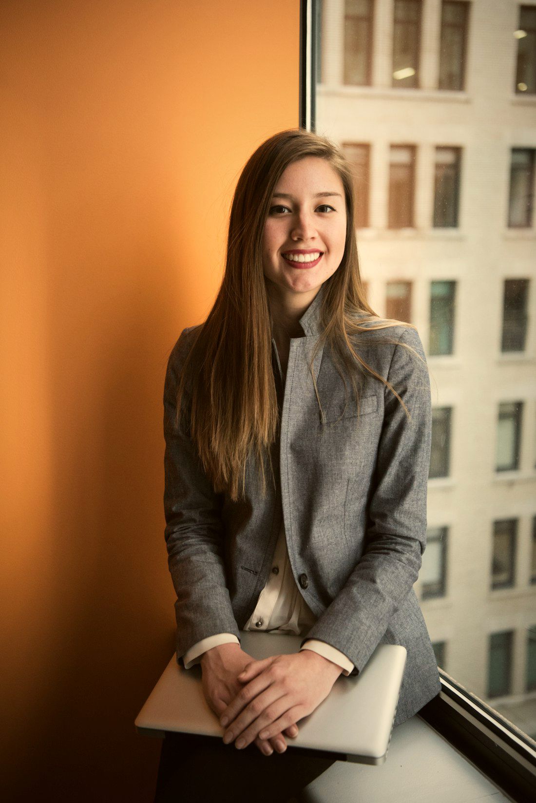 A real estate professional in a grey blazer